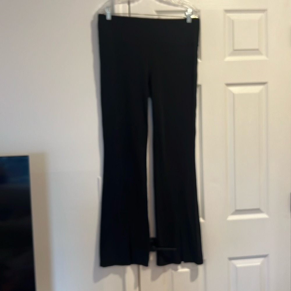 Athleta XL boot cut black leggings with slit at front bottom.